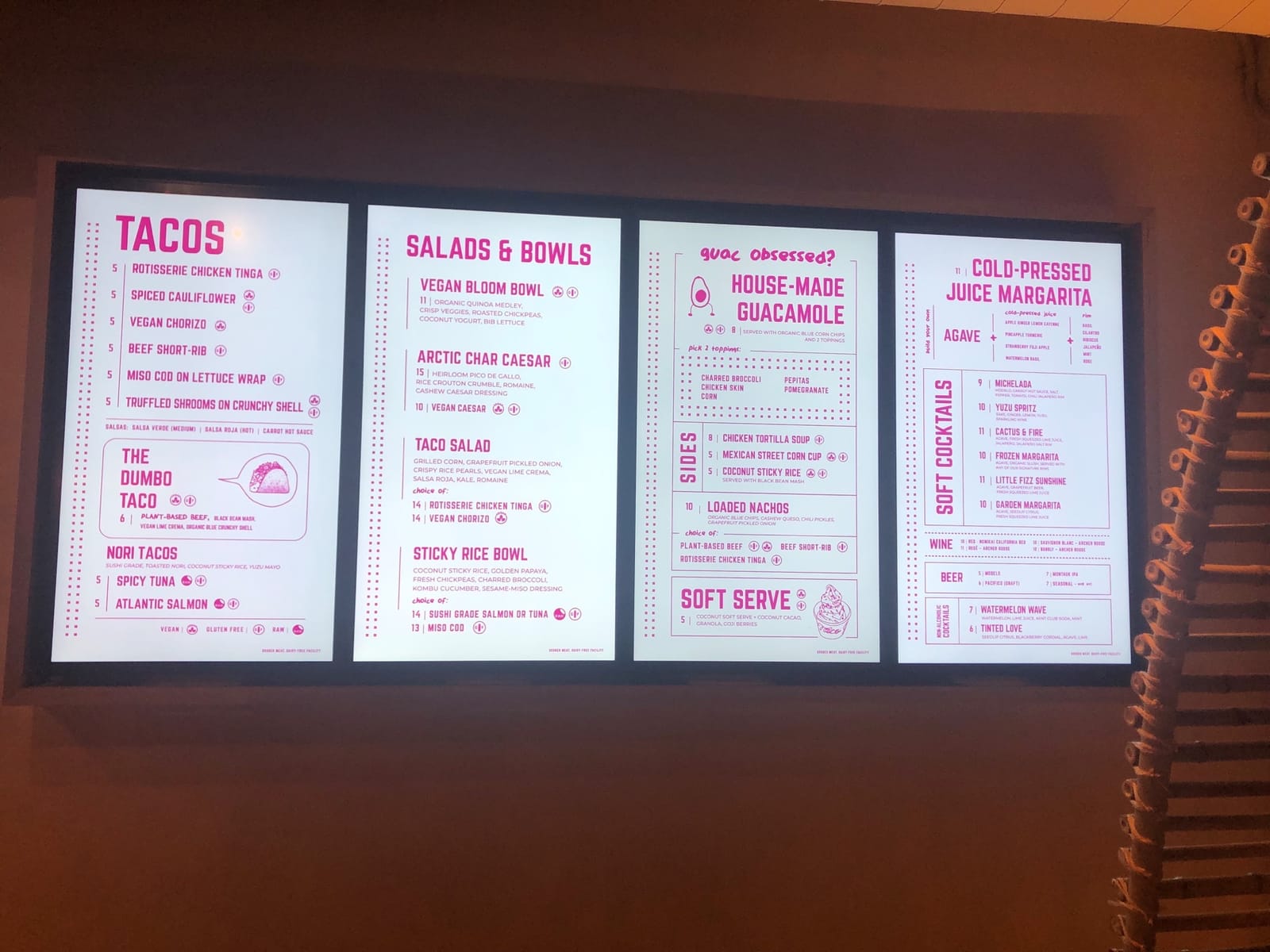 Four-panel digital menu board in a restaurant